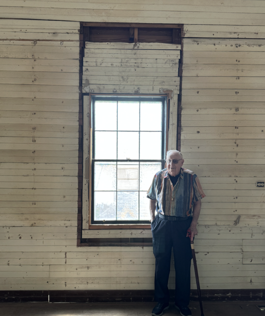 Author Richard McLean standing beside a historic church window.