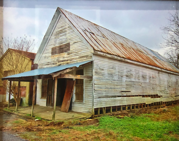 The historic Woolsey store building prior to its community restoration.