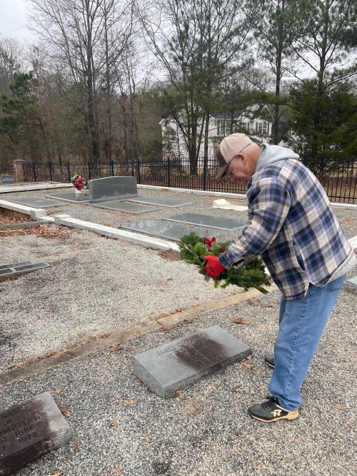 David Jenkins placing wreath on James Compton's grave Photo by Gail Jenkins © 2023